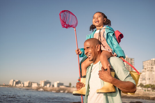 Family, children and piggyback with a father and daughter fishing while walking on the beach promenade. Nature, sky travel with a man and girl bonding together during summer vacation or holiday