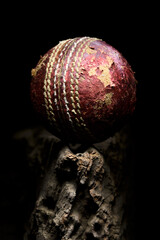 Cricket ball close-up used red leather on a wooden platform - 547099042