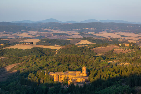 Sunrise view of the Abbey of Monte Oliveto Maggiore, a large Benedictine monastery in Tuscany, Italy