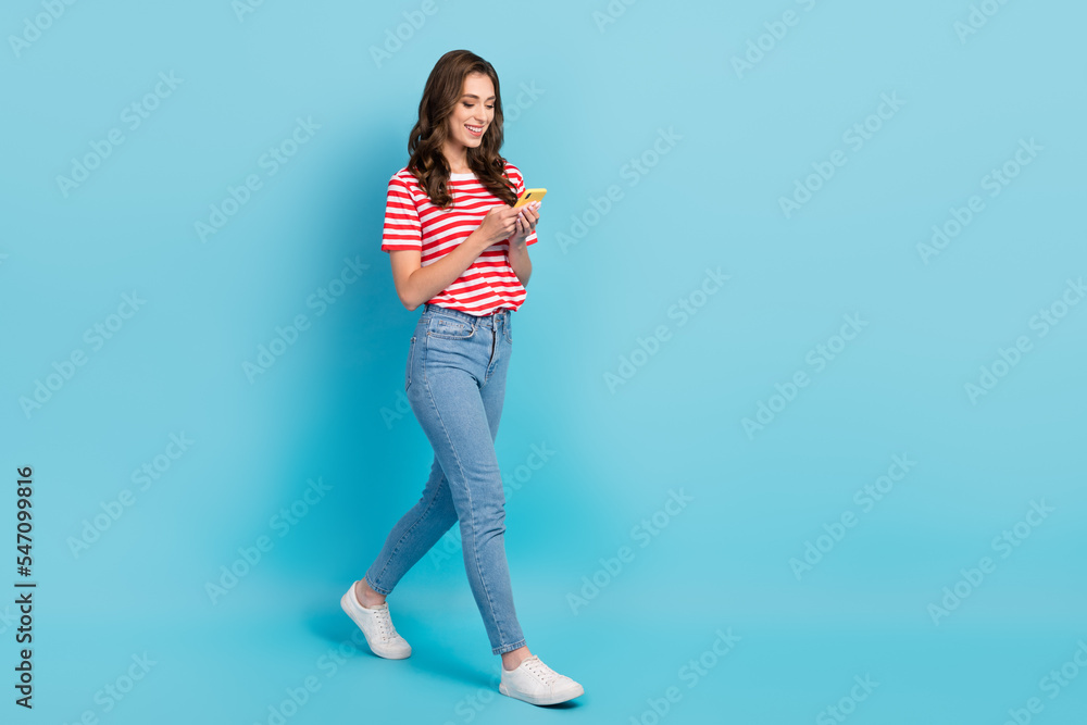 Poster full length photo of positive pretty girl move empty space use typing chatting modern device gadget 