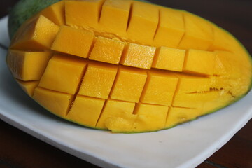 ripe mangoes sliced ​​in squares on a plate