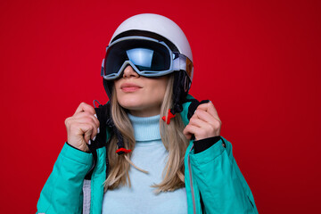Portrait of a young woman in a ski helmet and glasses