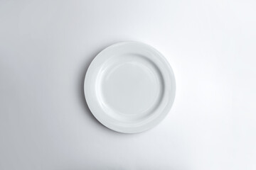 Top view of empty white plate isolated on white background