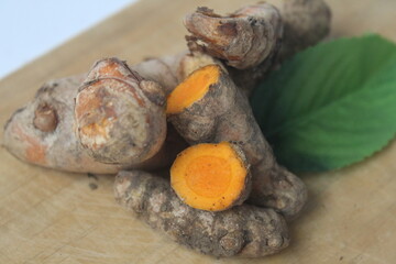 pieces of turmeric on a wooden board