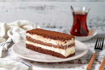 Tiramisu cake on a white wooden background. Italian food culture. Bakery desserts. close up