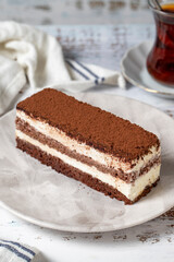 Tiramisu cake on a white wooden background. Italian food culture. Bakery desserts. close up