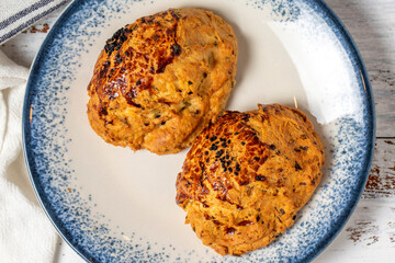 Pogaca with nigella sativa on a white background. Turkish pastry product. local name corek otlu pogaca. Top view