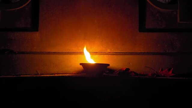 Candle Flames on Cemetery an Night, All Saint's Day , Death Holiday Lantern, 1 November Candles, Fallen Leaves, Blurred Background