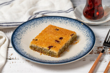 Kadayif with pistachio on a white wooden background. Mediterranean cuisine delicacies. close up