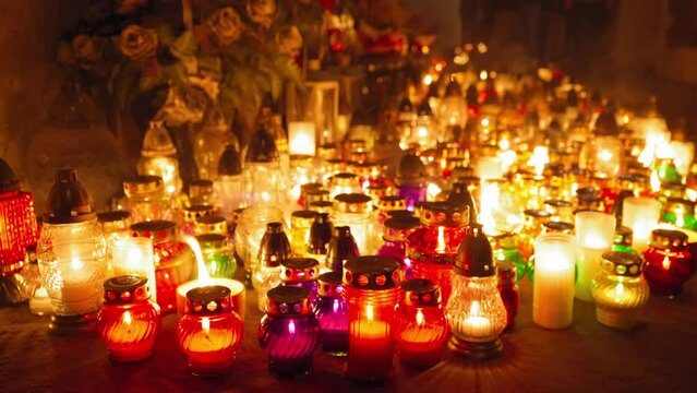 Candle Flames on Cemetery an Night, All Saint's Day , Death Holiday Lantern, 1 November Candles, Fallen Leaves, Blurred Background