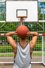 Man with a ball in front of a basket