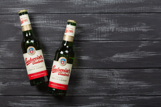 Budweiser Budvar beer bottles on a wooden background with copy space	