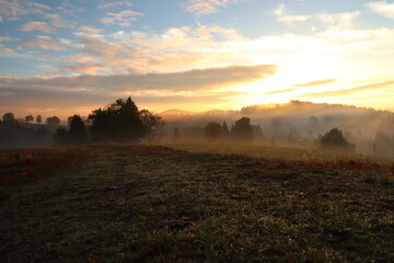 Fototapeta na wymiar panorama of mountain landscape with morning fog and sunrise
