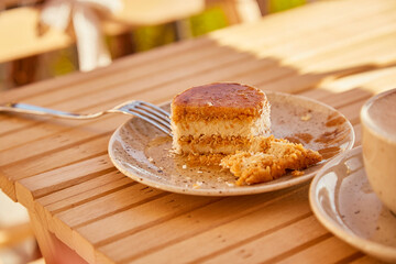 Aesthetic autumn no baking gluten free carrot dessert under hard shadows and cup of cappuccino.