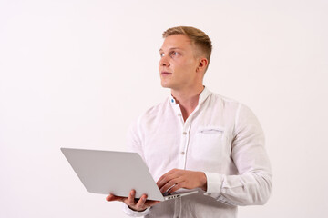 Caucasian businessman man with a laptop computer working on a white background, looking to the left