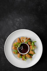 Cheese nuggets with sauce on a plate