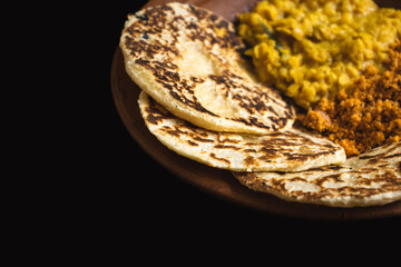 Sri Lankan style coconut roti bread with coconut sambol and dhal curry.