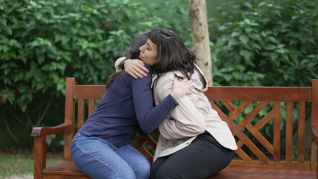 Sympathetic female friend in SUPPORT with suffering woman. Person in sorrow embracing supportive companion