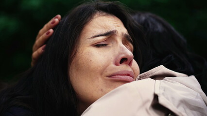 Sorrowful woman closeup face with negative emotion hugging friend