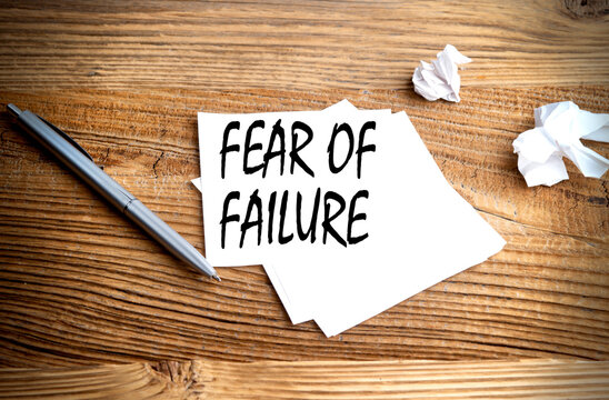 FEAR OF FAILURE text written on sticky on wooden background