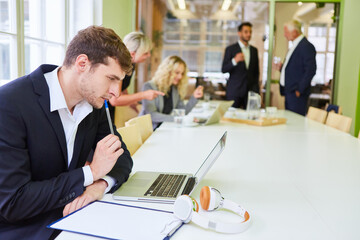 Businessman at the laptop is thinking about a problem