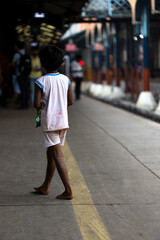 Barefoot child at New Delhi train station