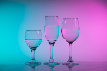 Wine glasses with neon multicolor light