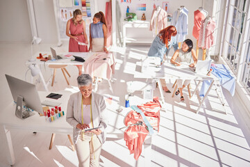Fashion workshop, diversity or women working with tablet, fabric or design research for creative...