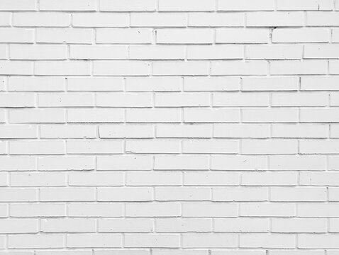 Old bright white brick tiles wall textured background. Kitchen wallpaper concept.