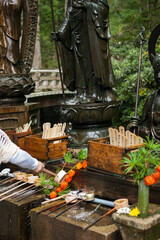 Ritual of throwing water over the Mizumuke Jizo statues in Okunoin, Wakayama, Koyasan