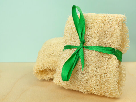 The loofah sponges. Vegetable sponge extracted from the loofah plant on a wooden background. Eco-friendly sponges, waste-free production. A way of life, the concept of no plastic and eco-friendly