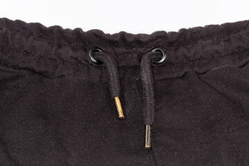 Waist of the pants with eyelets and drawstring with aglets