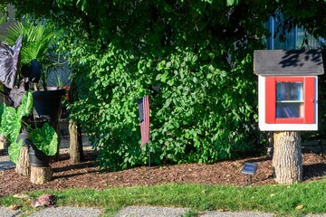 Public garden with a library book sharing stand in a residential neighborhood