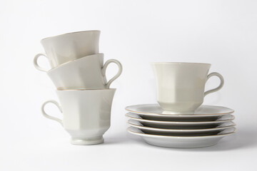 White coffee cups with a gold brim on white background