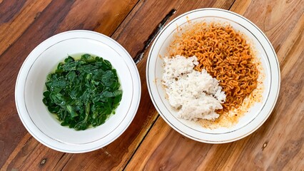 bowl of  moringa soup and instant fried noodles with rice.