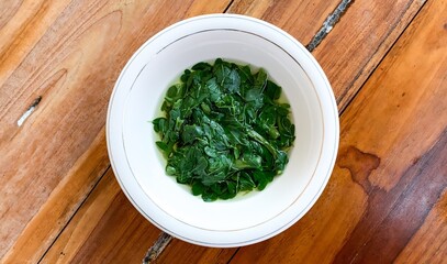bowl of sayur kelor or moringa soup.