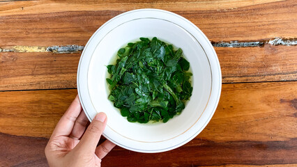 bowl of sayur kelor or moringa soup.
