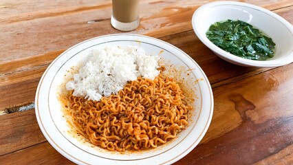 instant fried noodles with rice on a wooden table.