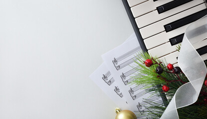 Christmas performance of piano with sheet music on white table