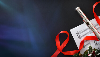 Christmas performance concept with flute on black table with spotlights © Davizro Photography