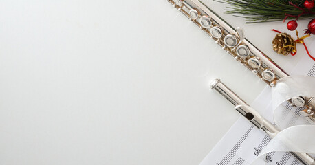 Background with metal flute on white table and Christmas decoration