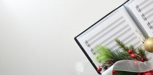 Choral christmas performance concept with sheet music on white table