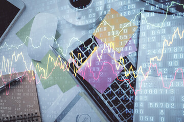 Multi exposure of financial chart drawing over table background with computer. Concept of research and analysis. Top view.