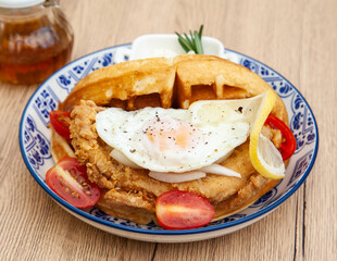 Waffle sandwich with fried chicken and egg