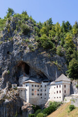 Fototapeta na wymiar Close to Postojna Cave, Karst world offers an unforgettable experience in fairytale world of knights who built Predjama Castle (Predjamski grad) Postojna, Slovenia (vertical photo)