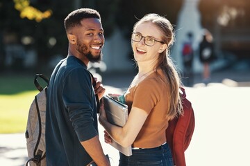 Education, university and students with couple who are interracial on campus for academic and learning. Black man, woman and smile in portrait with books to study, outdoor and college life.