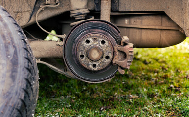 Car rear brake caliper. rear wheel removed. disc brake and caliper on the car