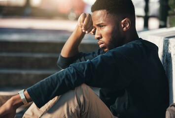 Stress, depression or sad black man on stairs thinking of dilemma, problem and crisis on outdoor...