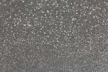 Abstract festive bokeh background. Glitter sparkling silver texture