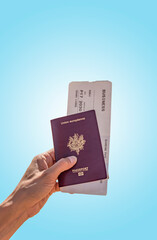 European Passport and Business Air ticket to go to Dubai with blue background hold by a woman, travel destination